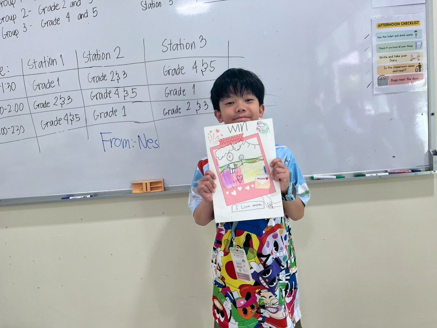 An elementary student proudly showing artwork