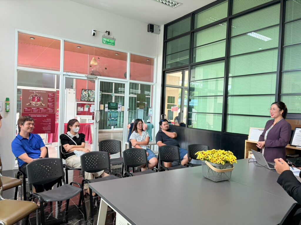 The Preschool Principal speaking to parents, with a basket of sunflowers on the table